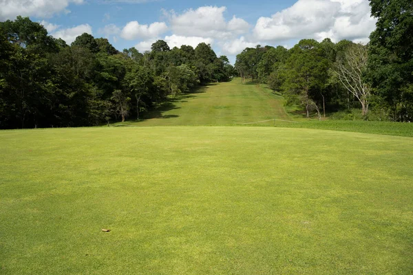 Background of evening golf course has sunlight shining down at golf course in Thailand. Nice scenery on a golf course at a late summer afternoon.