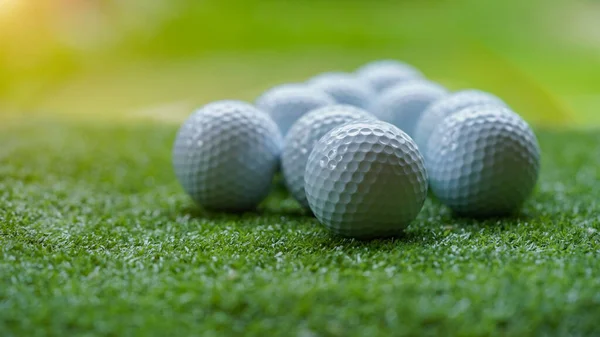 Golf ball on green grass with blur background. Golf balls on green grass in golf course.
