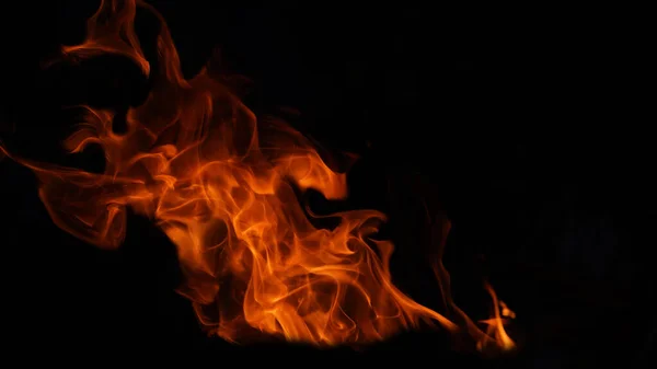 Stack of thermal energy close-up, red and yellow, heat energy igniting fuel during night/light on black background.