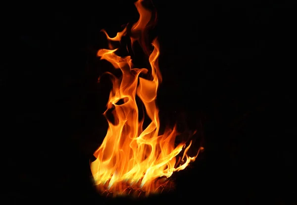 Stack of thermal energy close-up, red and yellow, heat energy igniting fuel during night/light on black background.