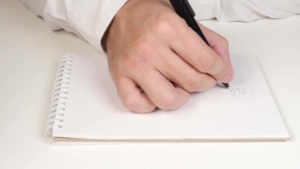 Hands Young Man White Shirt Drawing Squiggles White Notebook — Stock Video