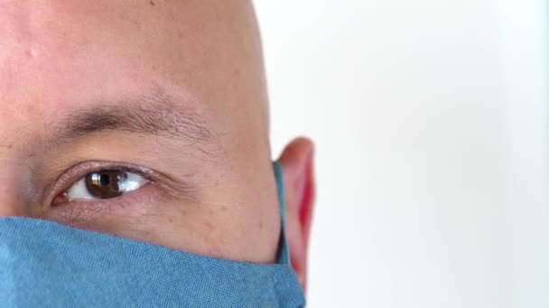 Man Brown Eyes Reusable Cotton Blue Mask Looks Camera Blinks — Stock Video