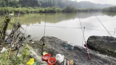 man sitting on the shore of the river