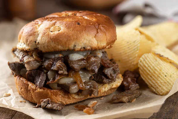 Closeup Hot Cheesesteak Sandwich Toasted Bun Potato Chips Rustic Wooden — Stock Photo, Image