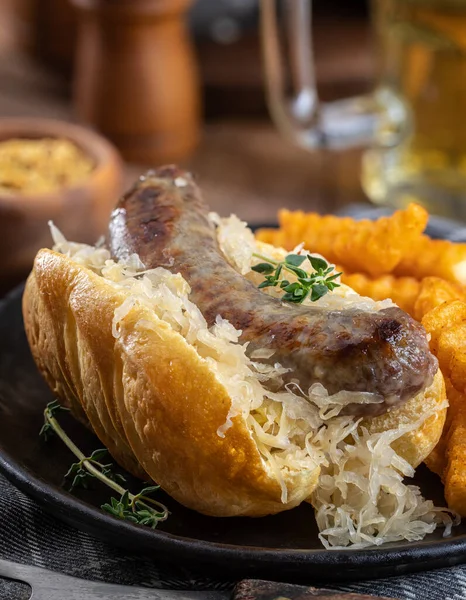 Closeup Grilled Bratwurst Sauerkraut Bun French Fries Black Plate — 스톡 사진