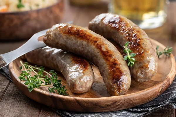 Closeup Fried Bratwurst Garnished Thyme Plate Rustic Wooden Table — Stock Fotó