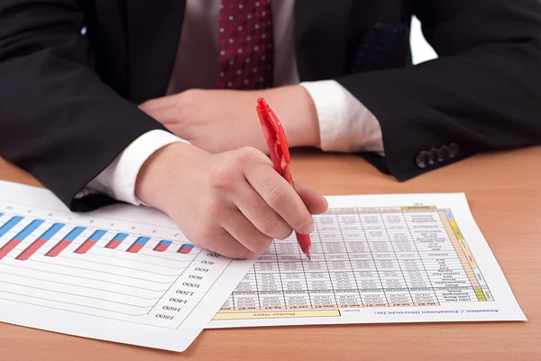Man in suit and financial papers — Stock Photo, Image