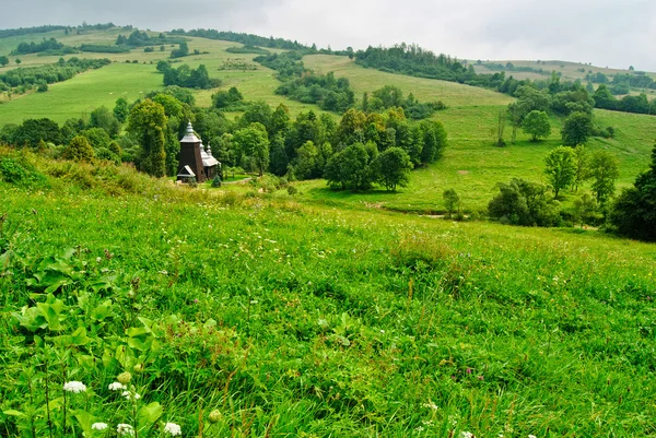 Rural landscape and church in Chyrowa — Stock Photo, Image