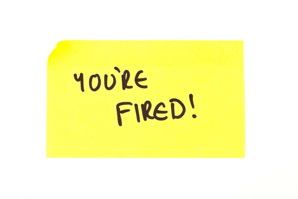 'You're Fired!' written on a sticky note — Stock Photo, Image