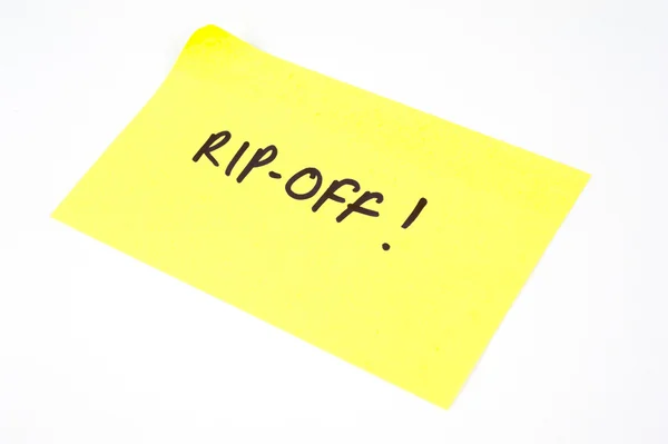 'Rip-Off!' written on a yellow sticky note — Stock Photo, Image