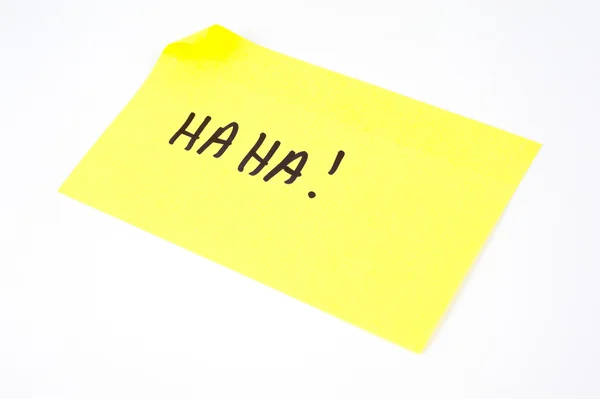 Haha! escrito em uma nota pegajosa amarela — Fotografia de Stock