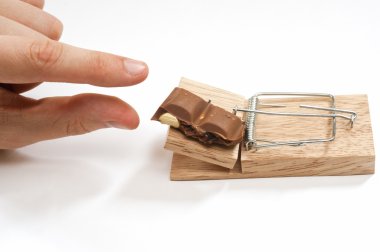 A mousetrap set with chocolate bait clipart
