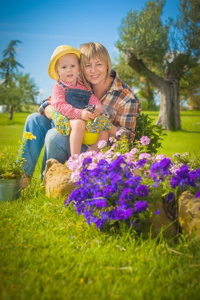 Kleines Mädchen hilft ihrer Mutter im Garten — Stockfoto