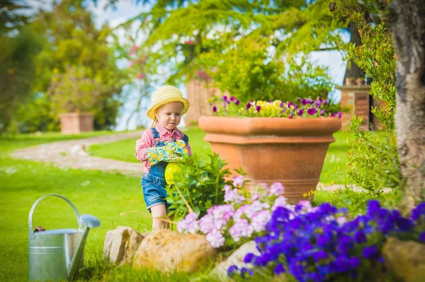 Liten flicka att hjälpa sin mamma i trädgården — Stockfoto