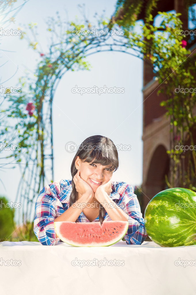 Healthy young woman-eating watermelon on a sunny day