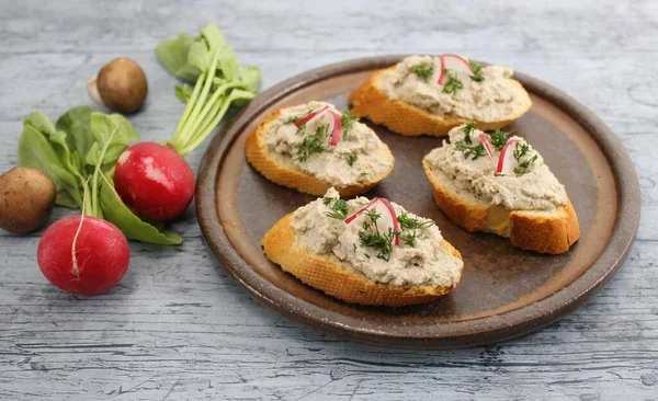 Mushroom Pate Bruschetta Garnished Red Radishes Brown Plate Blue Surface — Φωτογραφία Αρχείου