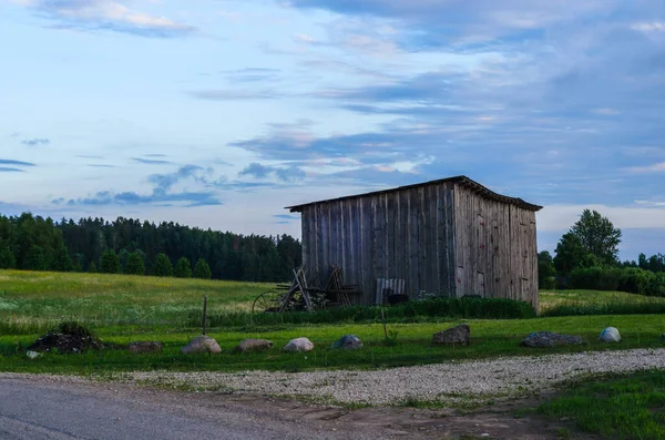 A farmer\'s old barn near a field