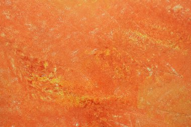 Boyalı yüzeyin turuncu desenli arka planı. Duvar boya ve macunla kaplıydı. Parlak turuncu arkaplan.