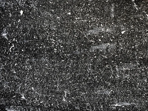 White ink droplets of paint on black background. Splatter background. Abstract dark wallpaper. Dark shabby concrete wall. stained texture. Painted backdrop.