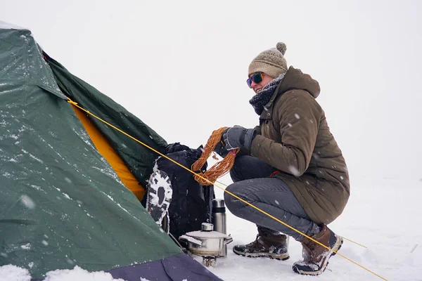 Tourist Sits Tent Set Snow Takes Out Cord Backpack Additional —  Fotos de Stock