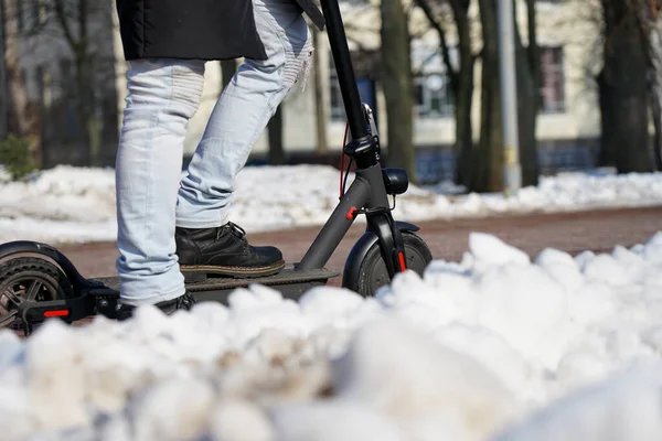 Guy Rides Electric Scooter Spring Park Wearing Warm Jacket Hat — Foto Stock