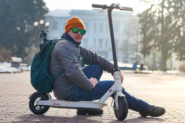 Guy Photographer Sits Electric Scooter Spring Park Wearing Warm Jacket — стокове фото