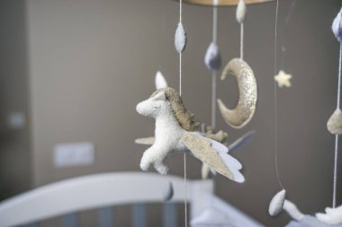 Bebek beşiği arabası. Oyuncaklar beşikte asılı.