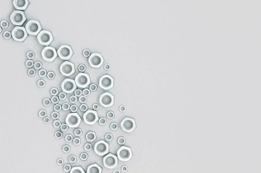 Gri arka planda metal altıgen fındıklar. Soyut sınır. Üst Görünüm Düz yatay Boşluğu Kopyala.