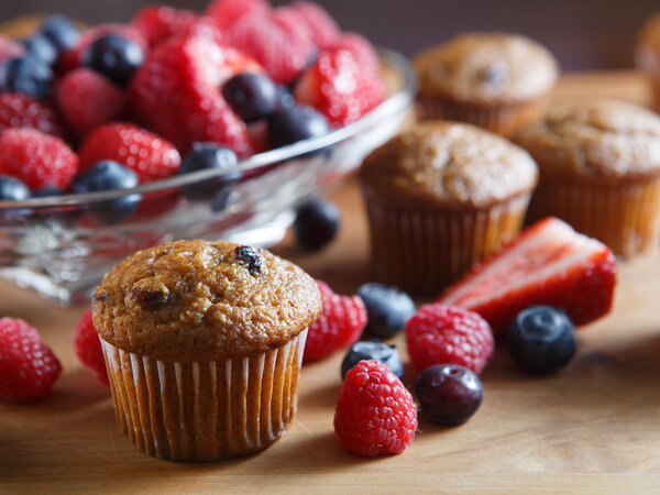 Fruit filled fresh muffins served with variety of organic early spring berries