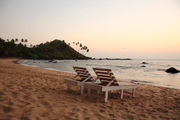 Sunbeds on the beach at sunset — Stock Photo, Image