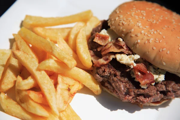Mirando hacia abajo en una jugosa hamburguesa de carne de res y patatas fritas — Foto de Stock