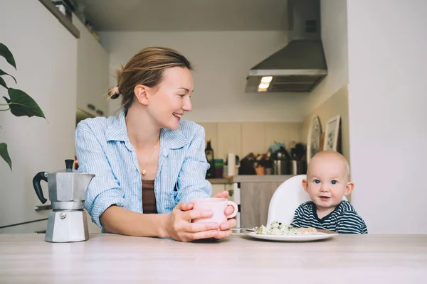 Loving Smiling Mother Baby Son Eating Breakfast Have Fun Kitchen — Stock Photo, Image