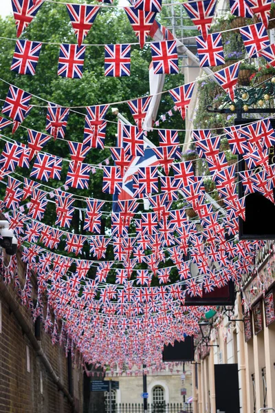 British Union Jack flag triangular hanging in preparation for a street party. Festive decorations of Union Jack bunting. Selective focus.
