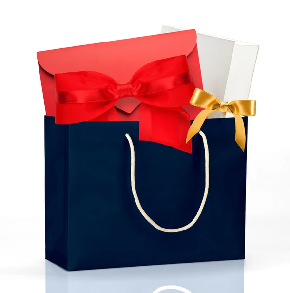 Dark blue shopping bag with gifts — Stock Photo, Image