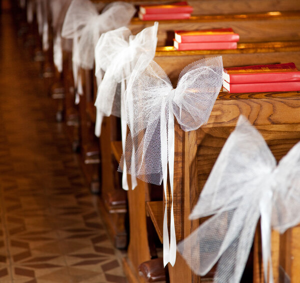 White bows in Catholic Church.