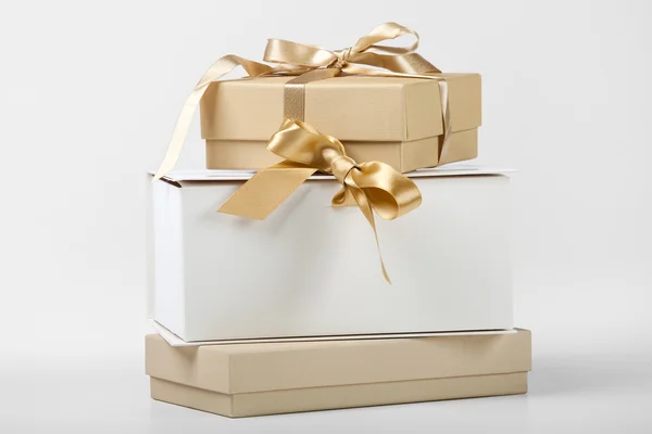 Three boxes with golden ribbon — Stock Photo, Image