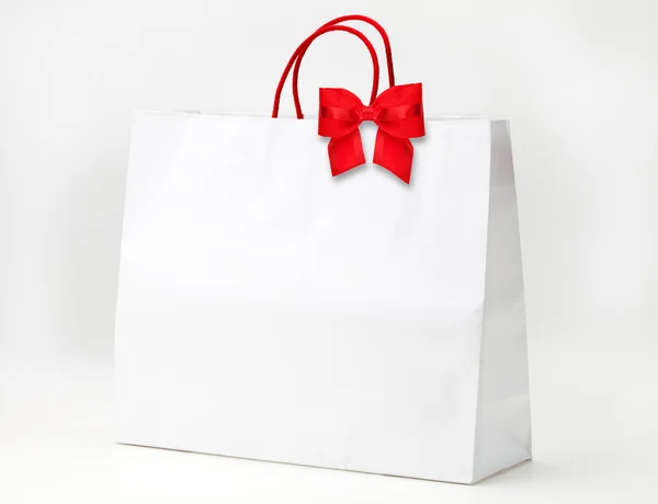 White shopping bag with red bow — Stock Photo, Image