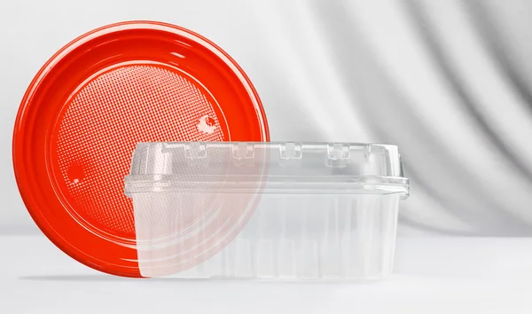 Plastic transparent container and red plastic plate — Stock Photo, Image