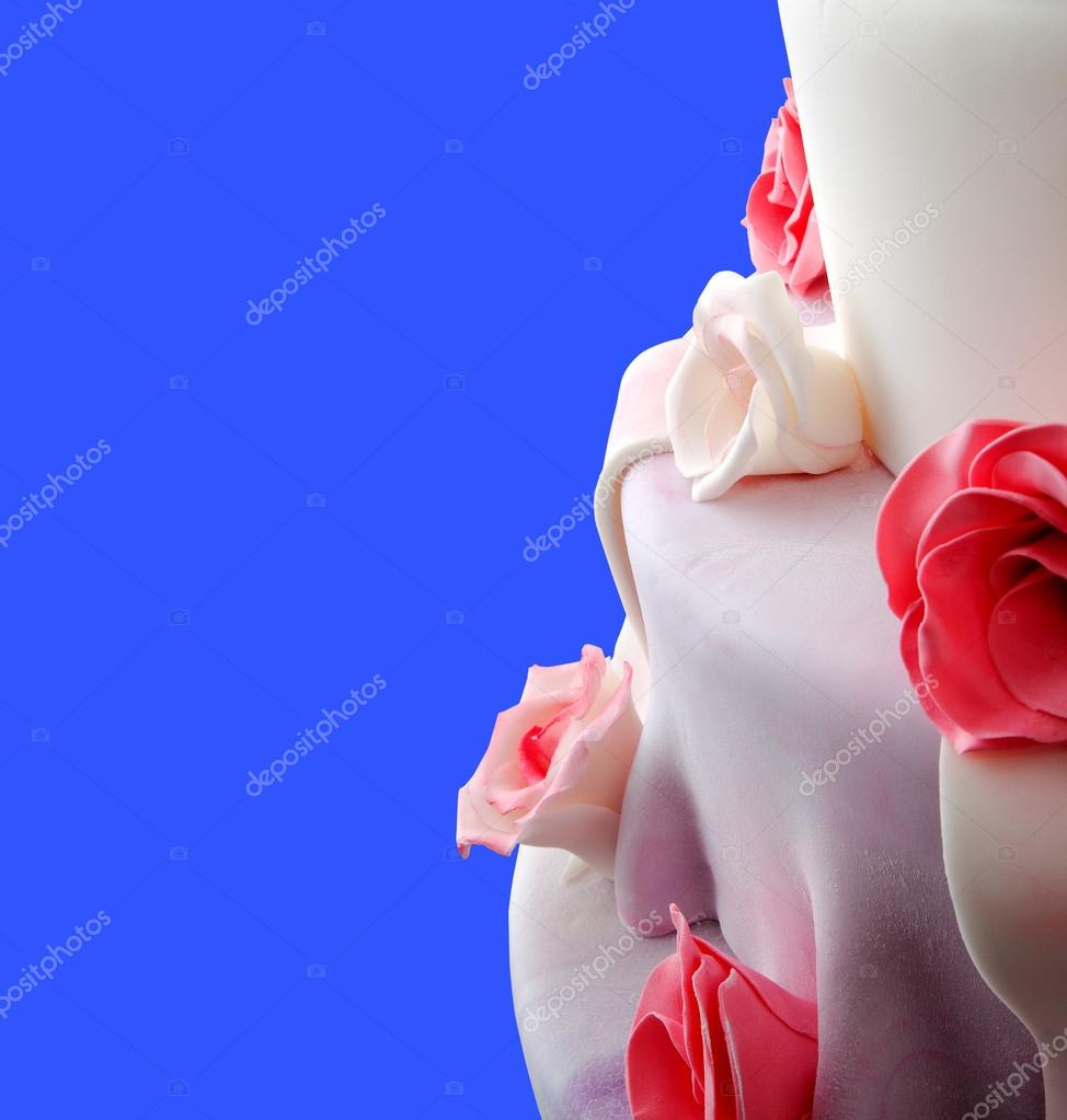 Detail of wedding cake with red roses on blue (space with your logo or text)