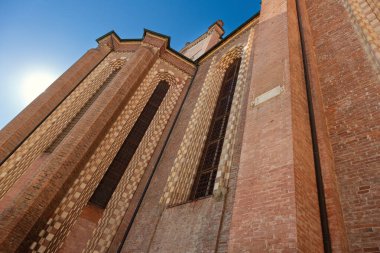 Detail of Asti Cathedral with sky and sun