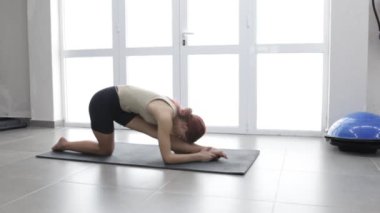 Fitness girl stretches on a yoga mat Place for an inscription