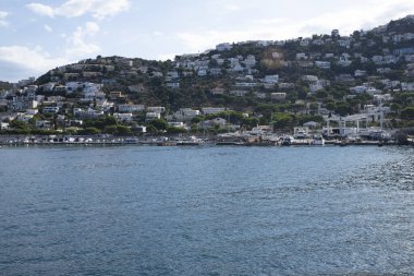 White houses in the mountains. City on the sea.