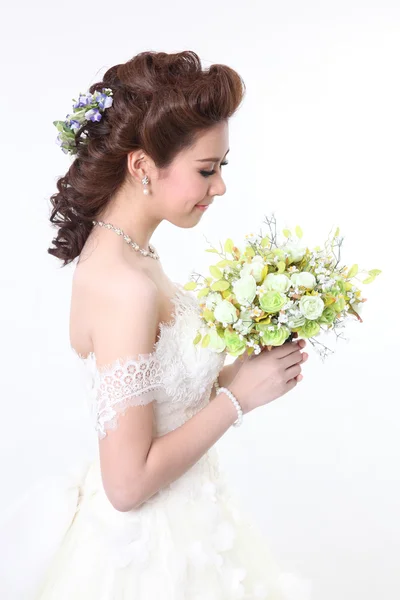 Young attractive bride with the bouquet of white roses Stock Picture