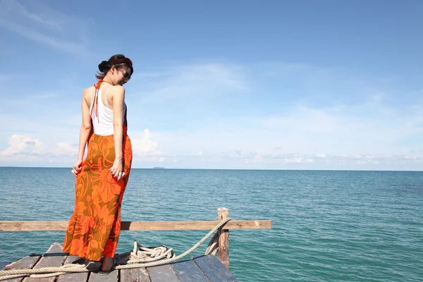 Sexy Woman on the bridge above sea — Stock Photo, Image