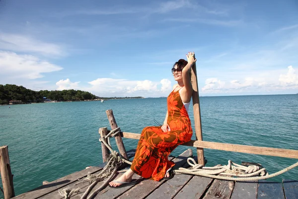 Sexy Woman on the bridge above sea — Stock Photo, Image