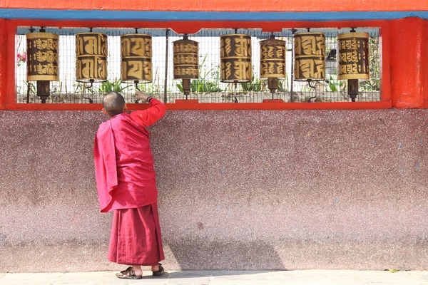 Monk near prayer wheels — Stock Photo, Image