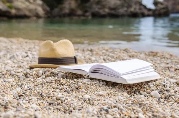 Boek bij strand tijdens de zomer lezing — Stockfoto