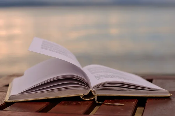 Book at beach during summer near the sea — Stock Photo, Image