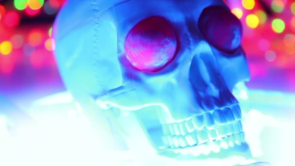 Skull on defocused colorful background, halloween scary head — Stock Video