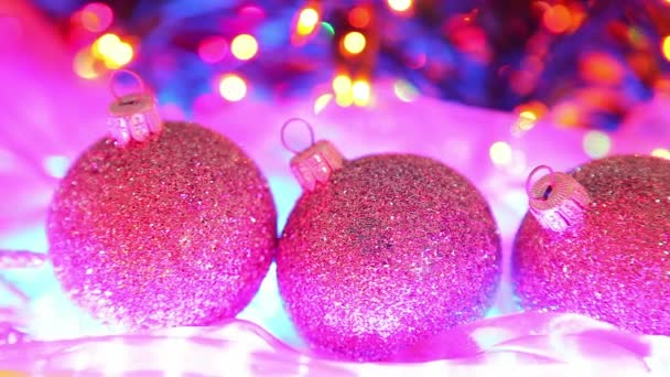 Beautiful Christmas balls on defocused tree lights background — Stock Video